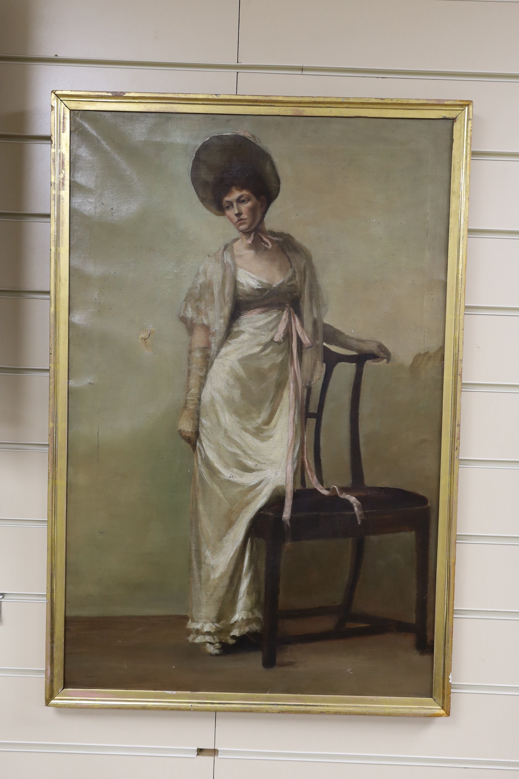 English School c.1900, oil on canvas, Full length portrait of a lady standing beside a chair, 74 x 47cm